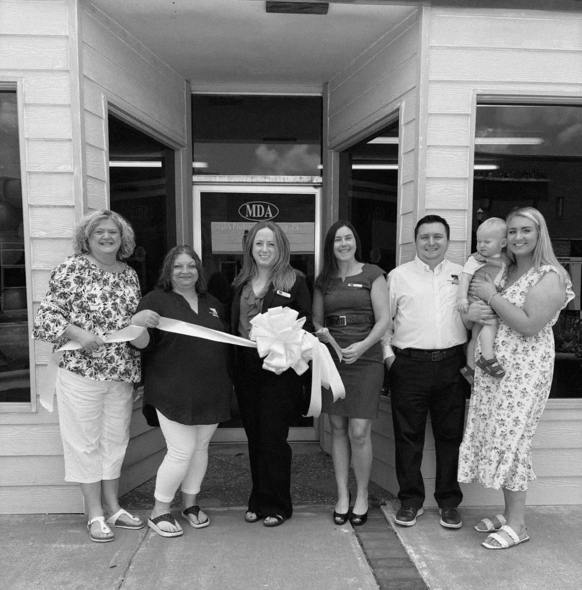 The MDA team cutting the ribbon at the Roanoke office